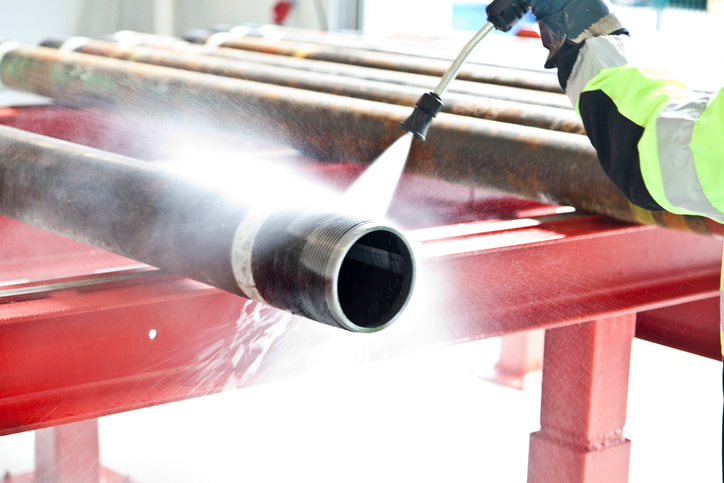 Industrial pressure washing and cleaning metal pipes in Atlanta, GA